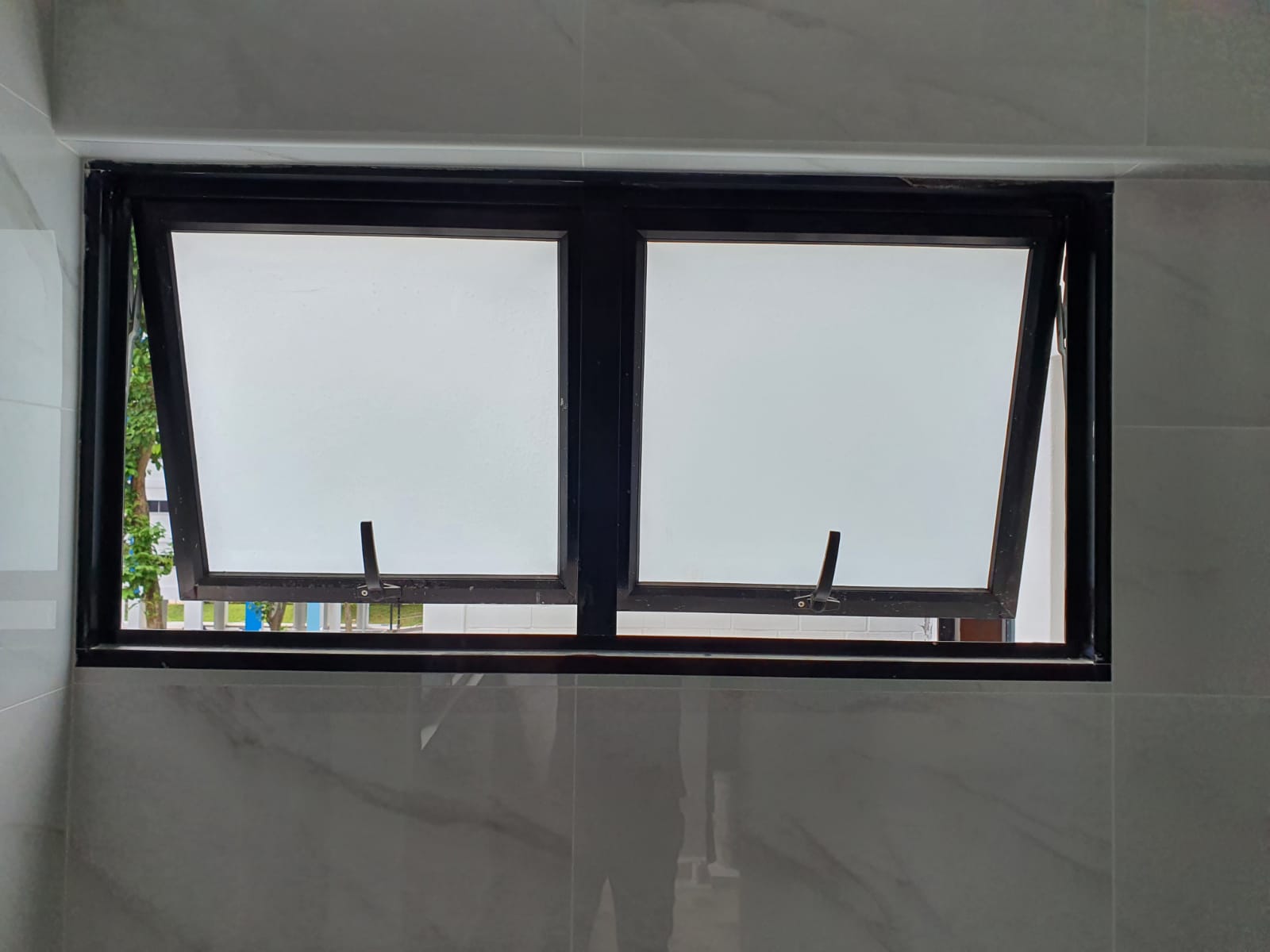 Awning windows in a tiled bathroom. - Home Aluminium Windows & Grilles Singapore