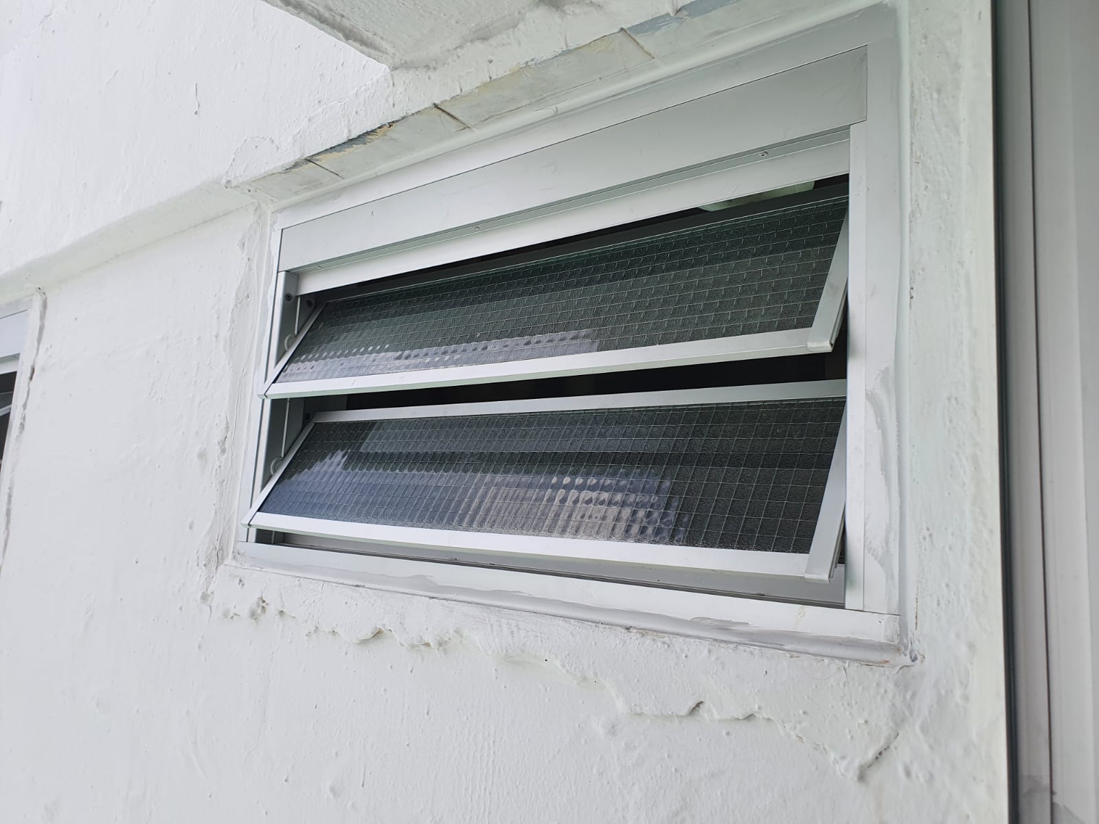 Awning window on stucco wall - Home Aluminium Windows & Grilles Singapore