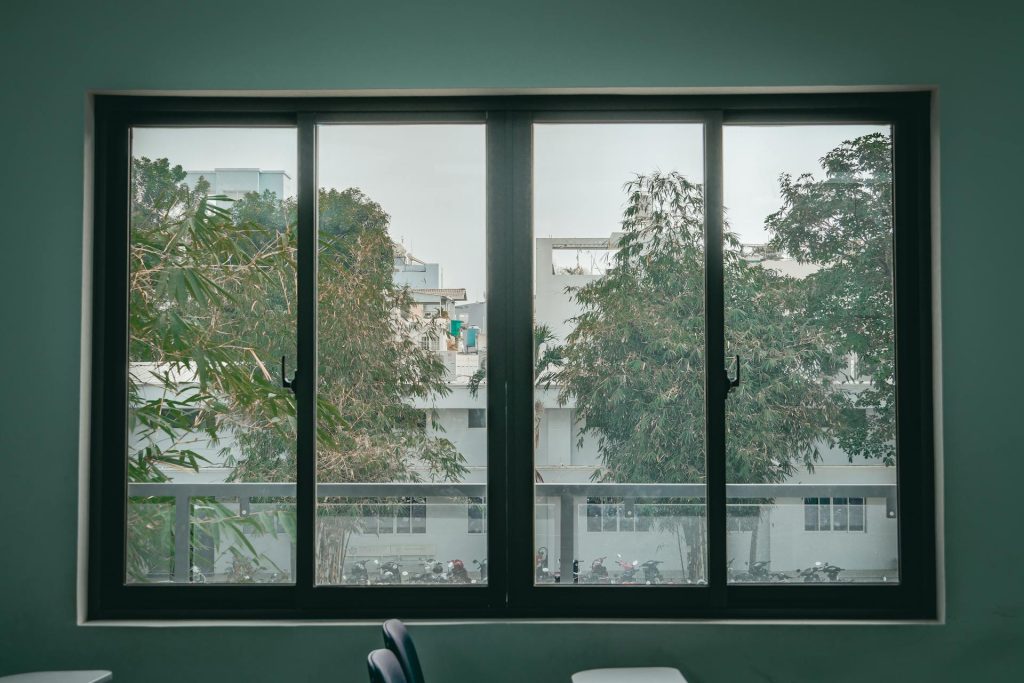 Window view of building and trees - Home Aluminium Windows & Grilles Singapore